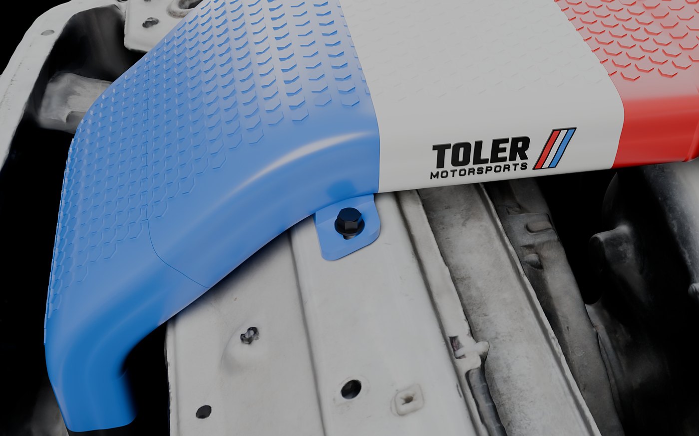 Mounting tab bolted to the core support