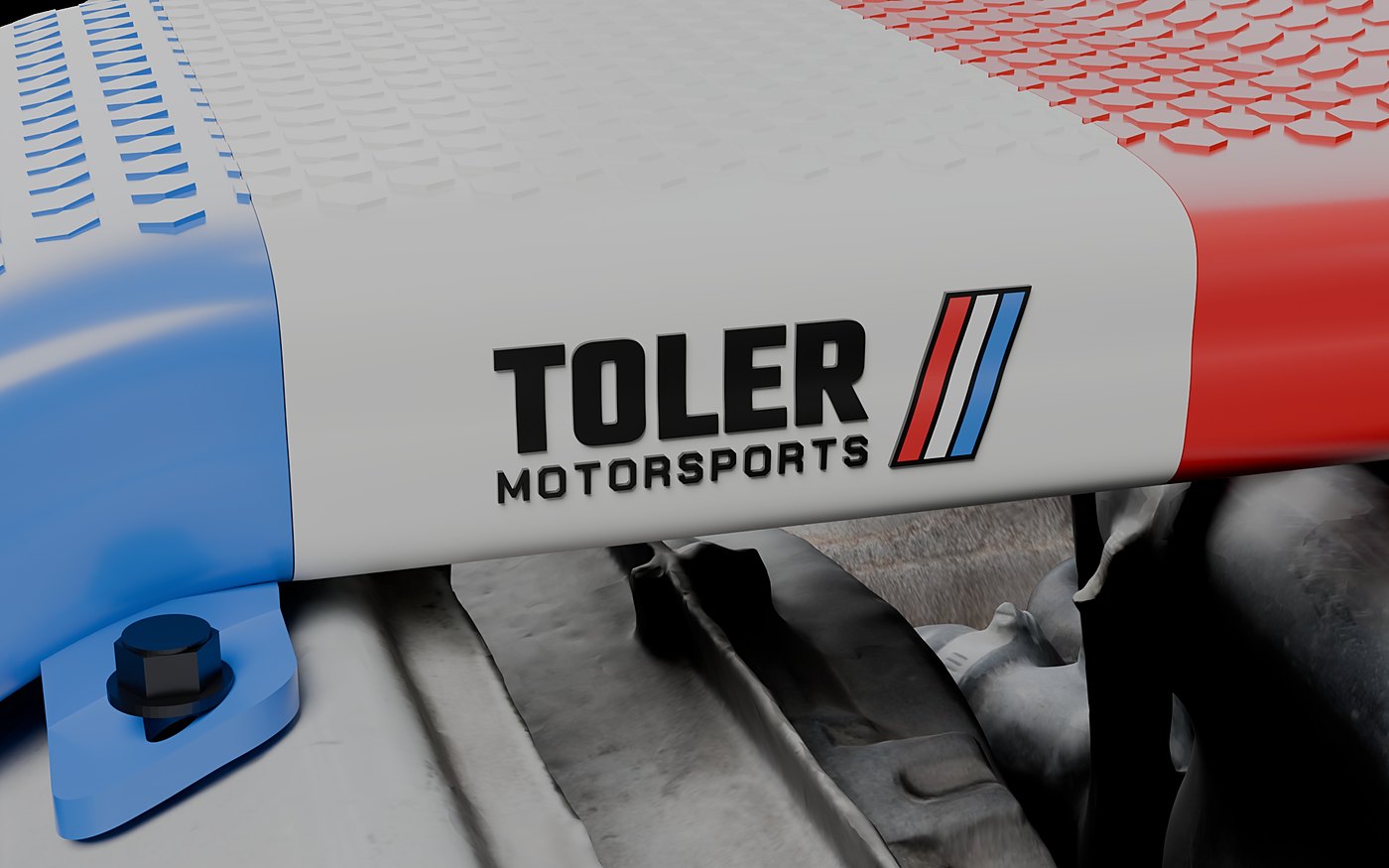 Raised Toler Motorsports badge on the core support section